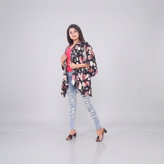 Black Bold Floral Satin Shrug worn over a pink top with light ripped jeans, full-length view