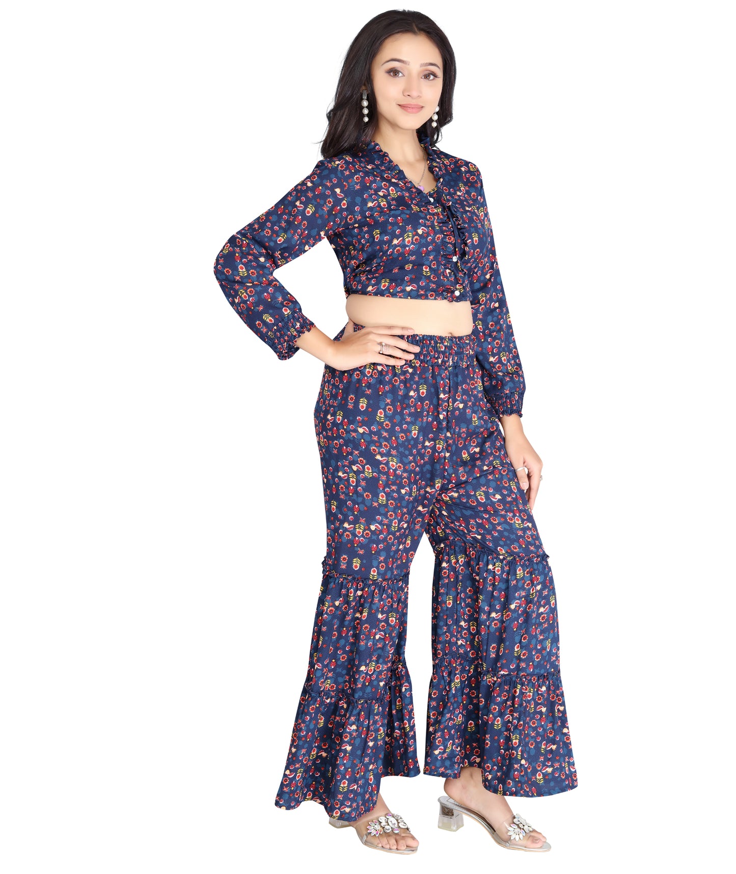 Model showcasing a high-quality polyester co-ord set in a vibrant print with a cropped top and layered flared pants.