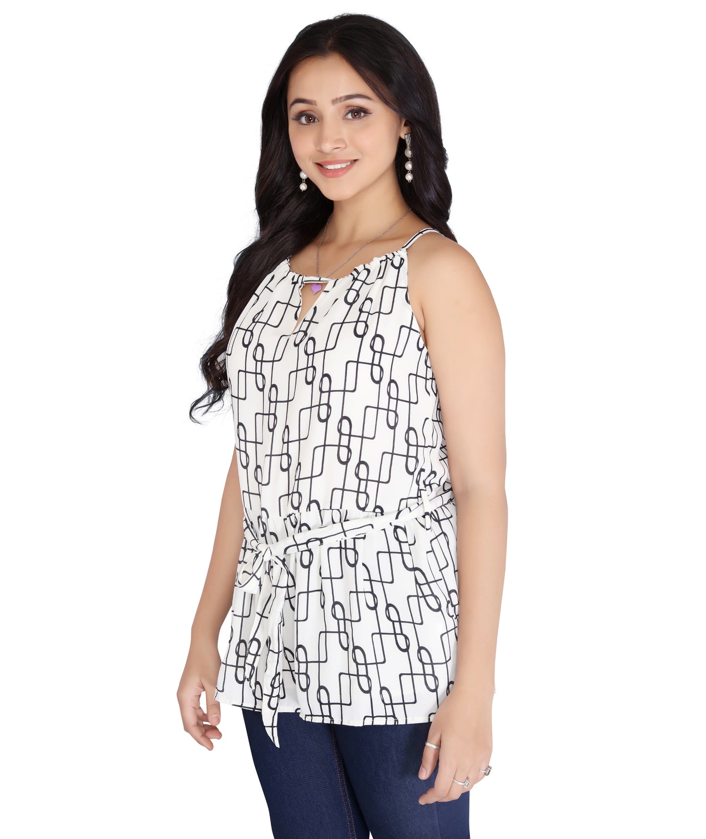 Side view of a stylish polyester sleeveless top in a black and white chain print, paired with denim for a casual chic look.