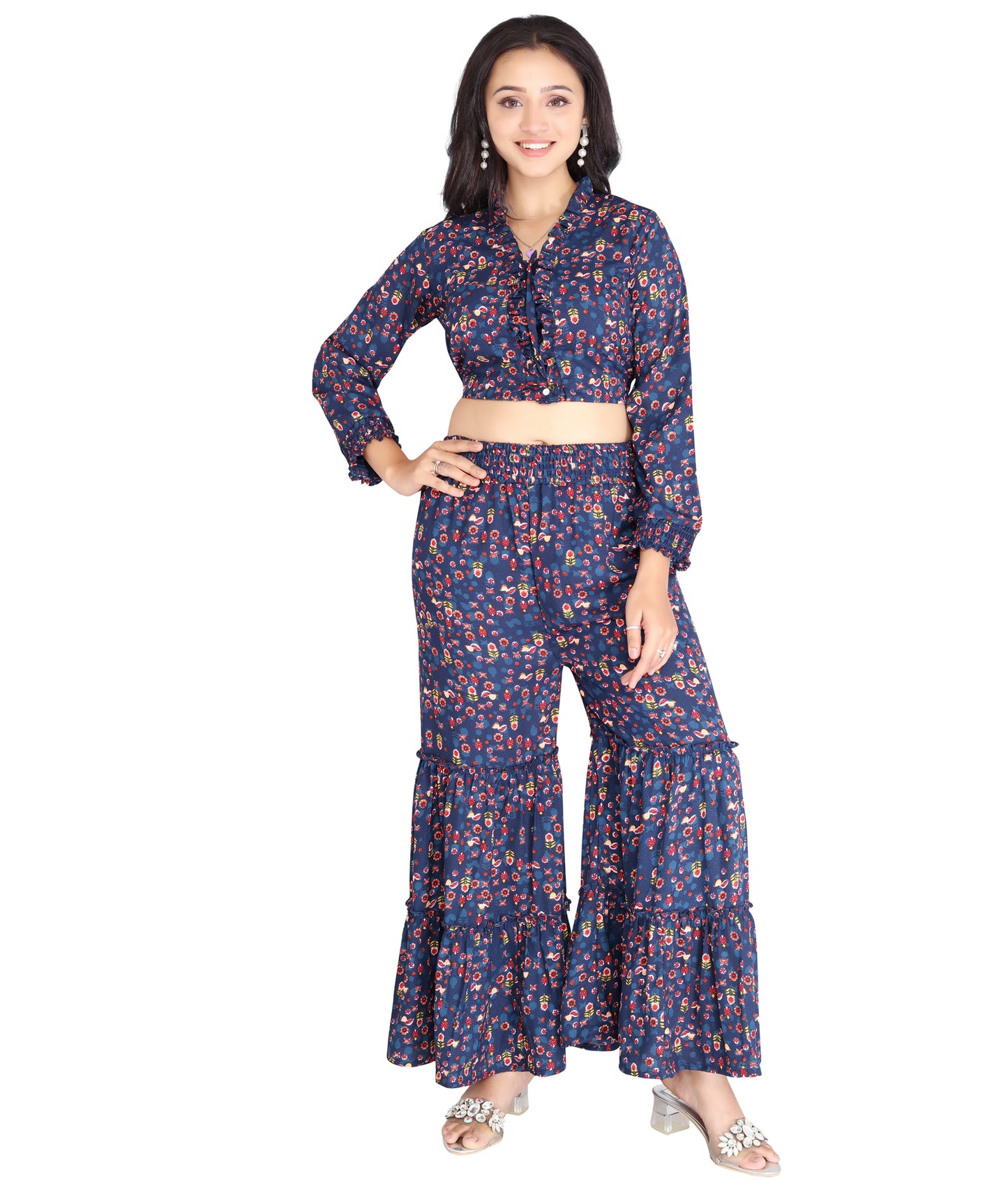 Complete front pose of a model in a printed high-quality polyester co-ord set with ruffled crop top and tiered flared pants.