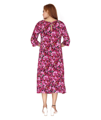 Back view of the Ladies Dress showing keyhole detail and flowy silhouette in a vibrant floral print.