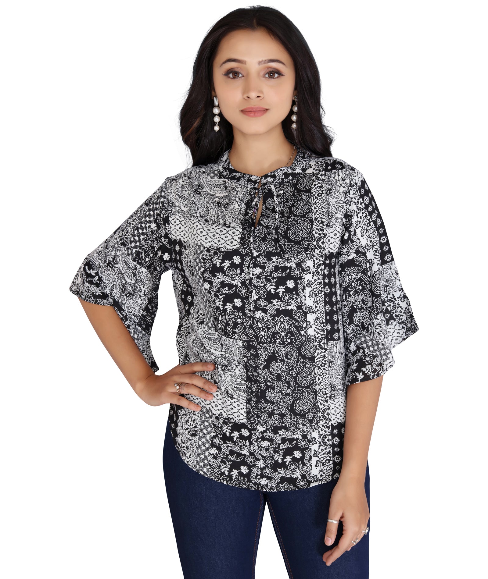 Front-facing model wearing a black and white printed polyester top with a tie-up neckline and 3/4th flared sleeves.