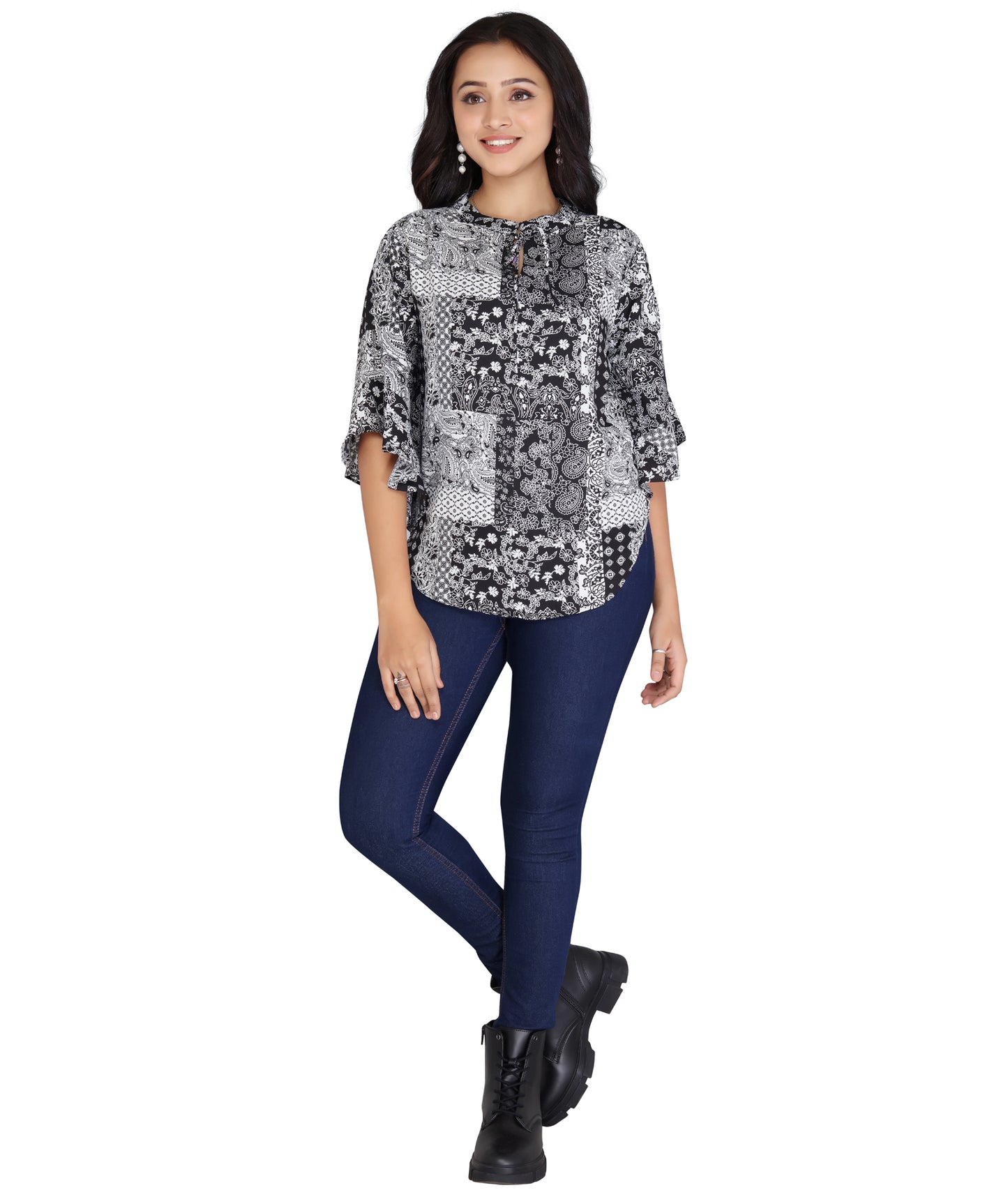 Full front view of a black and white printed polyester top paired with blue jeans, showcasing a comfortable and stylish fit.