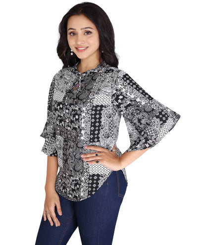 Side view of a black and white printed polyester top with flared sleeves, highlighting its intricate design and chic appeal.